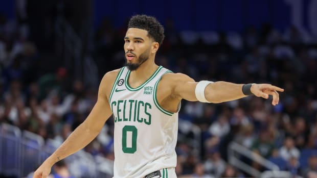 Jayson Tatum points to a teammate.
